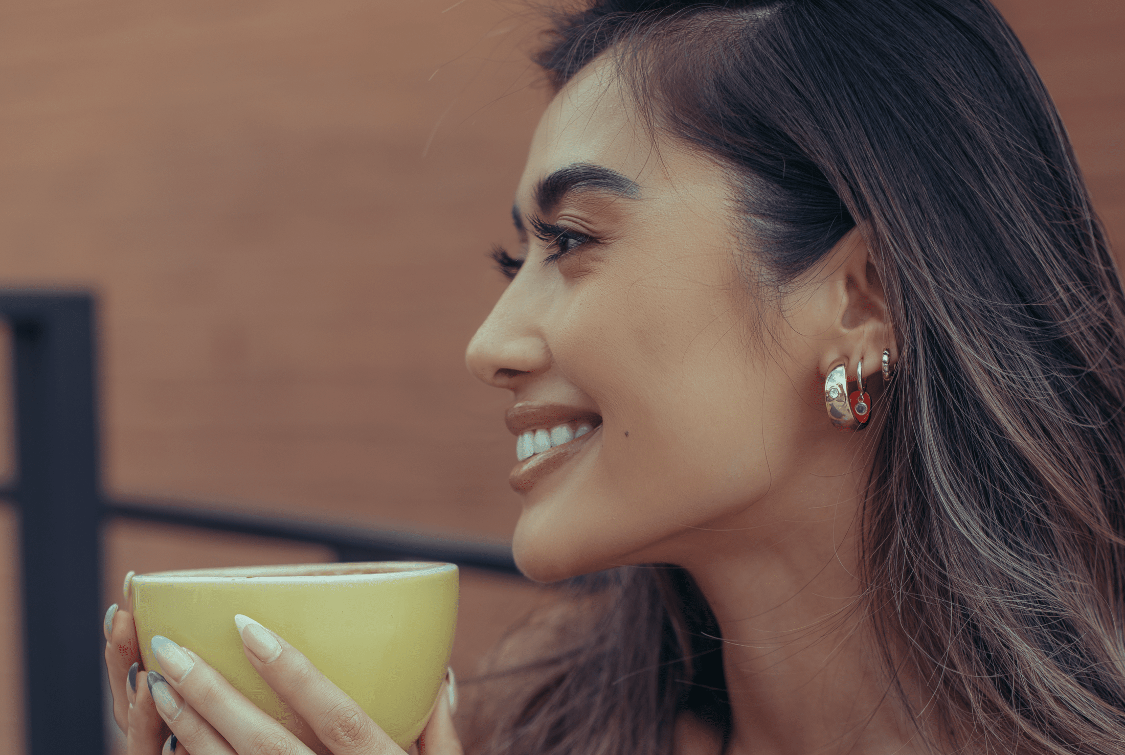 Close-up on a woman's face and the cup of tea she's holding